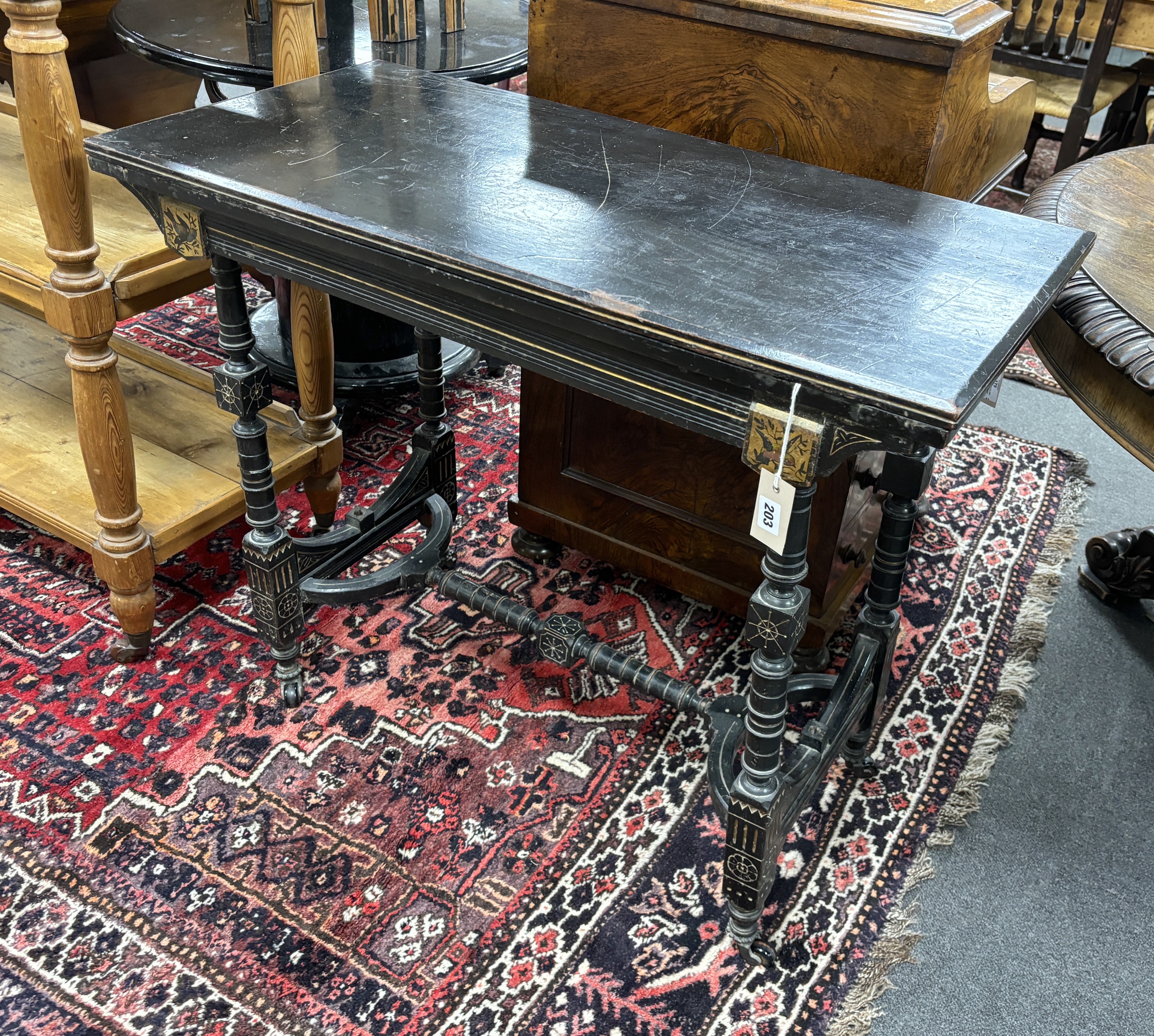 A late Victorian aesthetic movement ebonised folding card table, width 92cm, depth 44cm, height 76cm